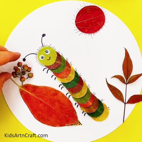 Making Sunrays And Adding More Leaves-Crafting a delightful caterpillar with leaves for kids