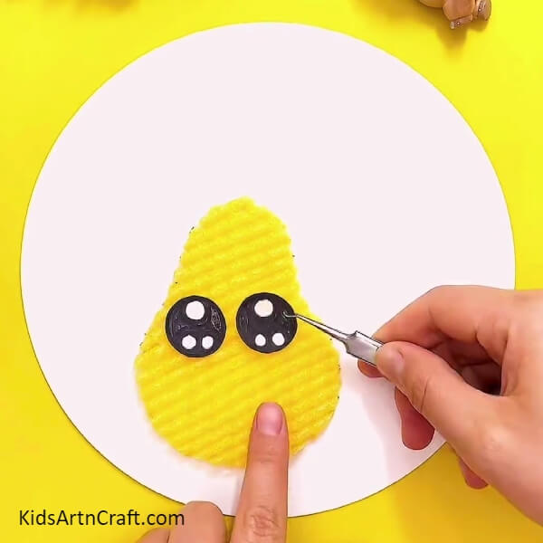 Creating and pasting eyes for pear- A fun, easy-to-follow guide on creating a Foam Pear masterpiece with youngsters.