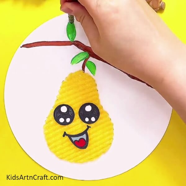 Drawing leaves with green paint- Kid-oriented tutorial on how to make a delightful Foam Pear craft step by step.