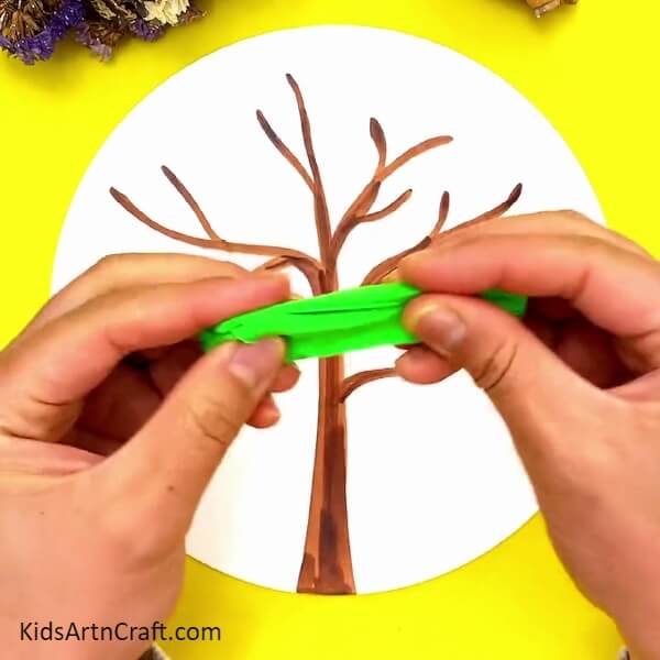 Take White Craft Paper And Green Clay-Guide on Creating a Clay Bird Sculpture for Kids