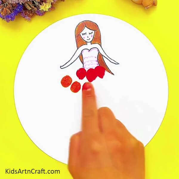 Creating The Doll's Gown With Finger Painting-Making a clay doll is a fun activity for kids to explore with this tutorial. 