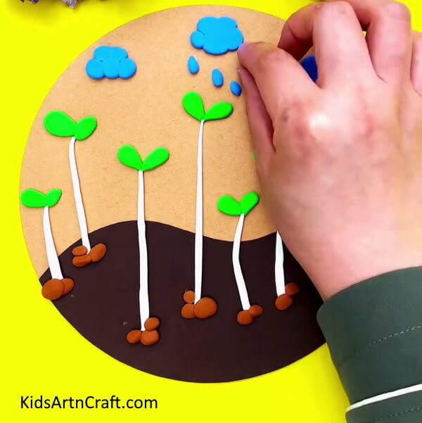Add Raindrops- Home sprouting using clay as a kid-friendly art activity.