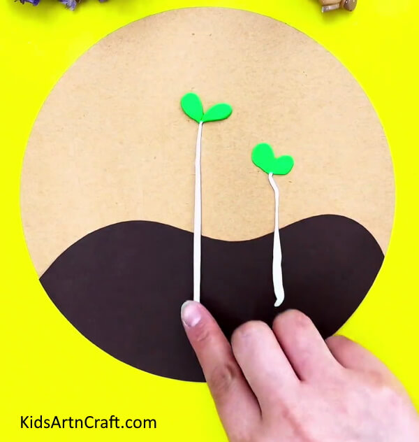 Attach And Shape The Stems- Growing your own seedlings through clay as a way of art for children.