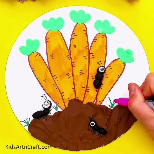 Draw tiny bushes on the  sheet with a green sketch pen- A Simple Guide to Growing Carrots with Art Projects
