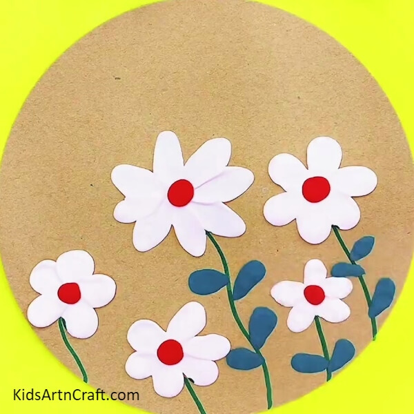 Make leaves for each flower with dark blue clay- A Clay Garden Project for the Novice Crafter 