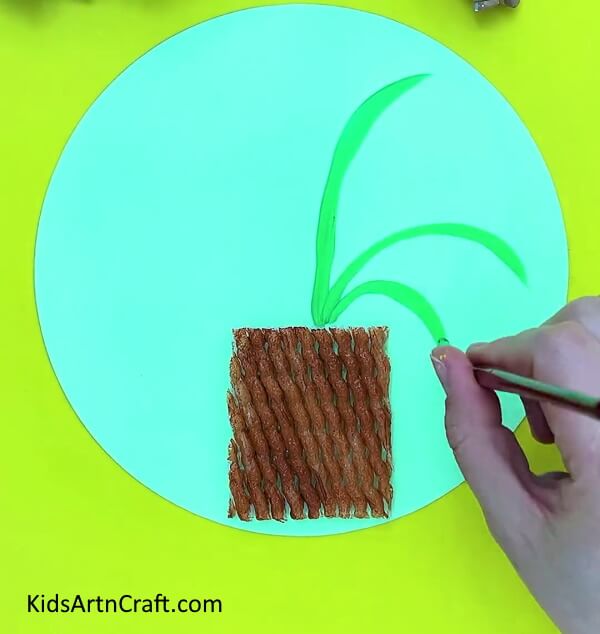 Making leaves and stem. Step-by-step guide of Easy Fruit Foam Net Flower Pot Artwork For Kids