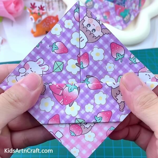 Folding front piece one more time- Follow this step-by-step guide to craft a Paper Basket Origami for kids.
