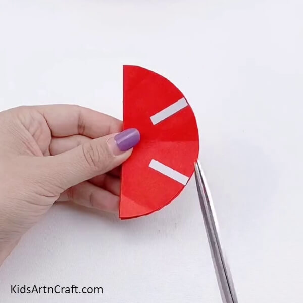 Cutting The Extra Edges Using Scissors To Make Apple Shape-