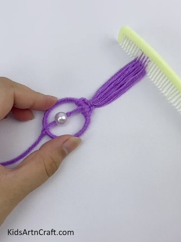 Comb The Purple Yarn With A Comb- Crafting an eye-catching wall hanging with fruit foam and chopsticks. 