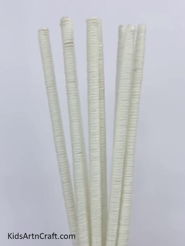 Wrap The White Yarn On All Eight Chopsticks- Constructing a Wall Hanging Utilizing Fruit Foam and Chopsticks 