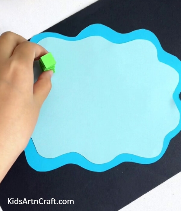 Pasting The Spring On The Sheet-Simple steps for a frog and lily pad paper craft for newbies