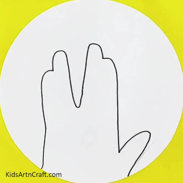 Overdrawing The Pencil Outline With Black Marker-Learn how to draw a tree in the shape of a hand with this guide for kids