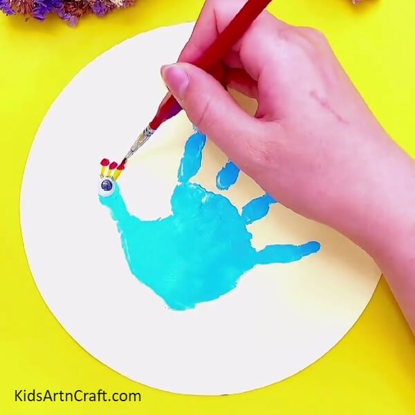 Take Red And Yellow Poster Colors And Paint As Shown- A fun and creative art activity for the novice artist – handprint peacock