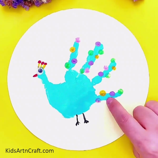 Now, Make More Of Those Finger Impressions- For the new artist – a handprint peacock painting idea