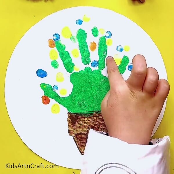 Use More Colors To Stamp On The Sheet- How to make a handprint flowerpot using paints