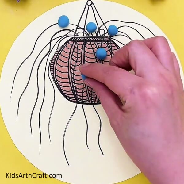 Make Balls With Blue Clay And Stick It On Wavy Lines- Step-by-Step Guide to Making a Hanging Plant Pot with Kids 