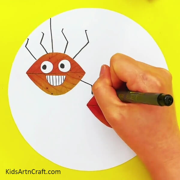 Drawing Legs Of The First Spider -Crafting Leaves into Spider Shapes Kids Activity