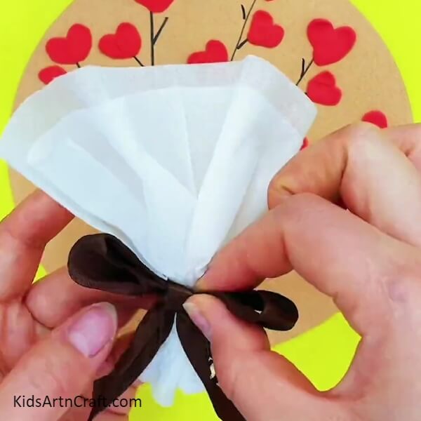 Make A Bow Out Of The Ribbon- Children can make a heart-shaped floral arrangement out of clay and paper