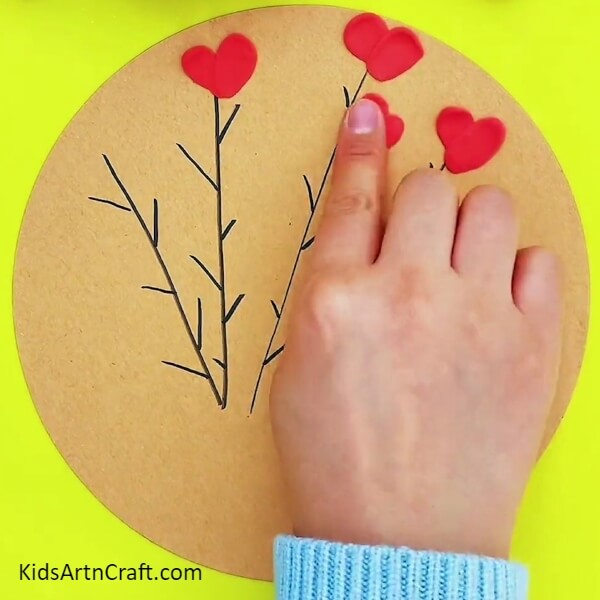 Make More Heart-shaped Flowers-A fun craft project for kids using clay, paper, and heart-shaped elements