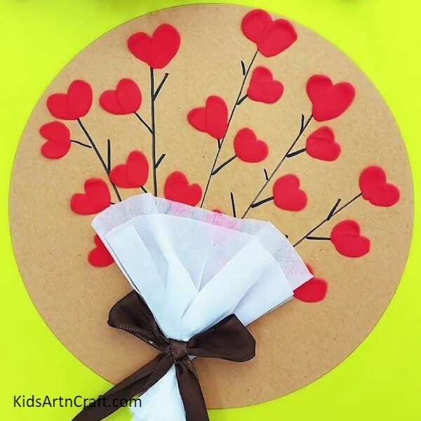Pasting The Tissue On The Cardboard-Kids can craft a bouquet of hearts with clay and paper