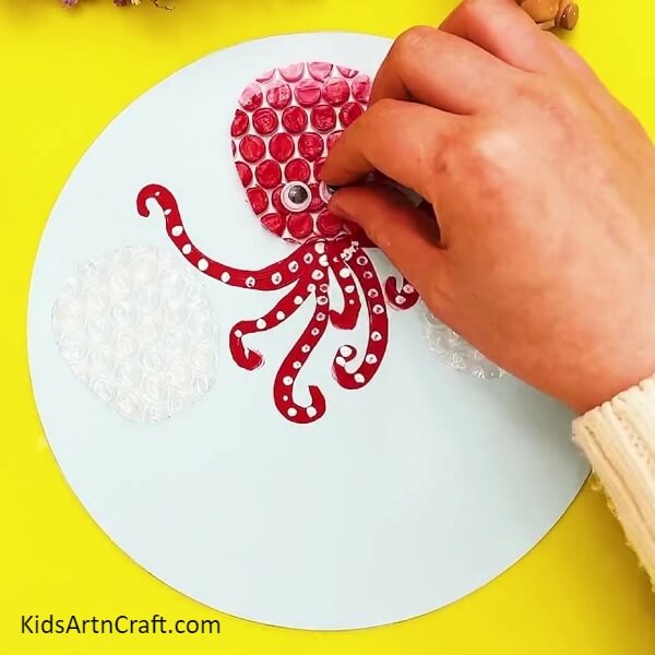 Pasting Googly Eyes For Our First Octopus-Tutorial on forming an octopus craft from bubble wrap for young ones
