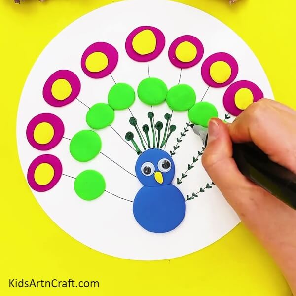 Decorating The Feathers-Making a clay peacock for kids in a few steps