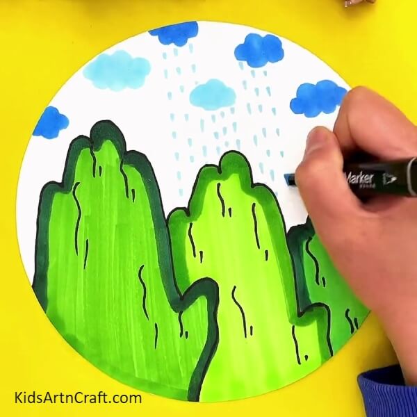 Drawing Raindrops From Clouds. step-by-step guide to make beautiful mountain for kids