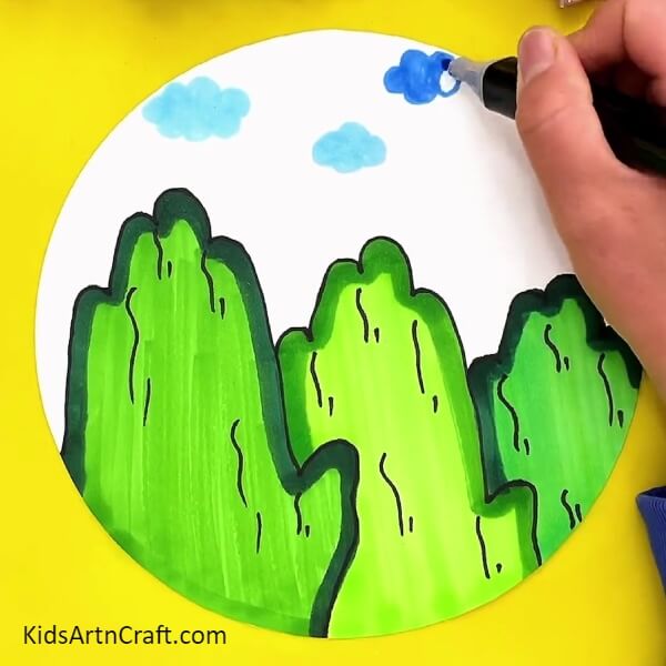 Drawing Clouds With A Dark Blue Sketch Pen. How To Make Mountain Scenery Drawing For Kids Tutorial