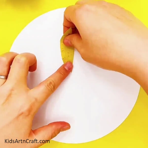 Cut Leaves Shapes From The Yellow Color Craft Paper-Creating a Paper-Leaf Peacock Craft for Children
