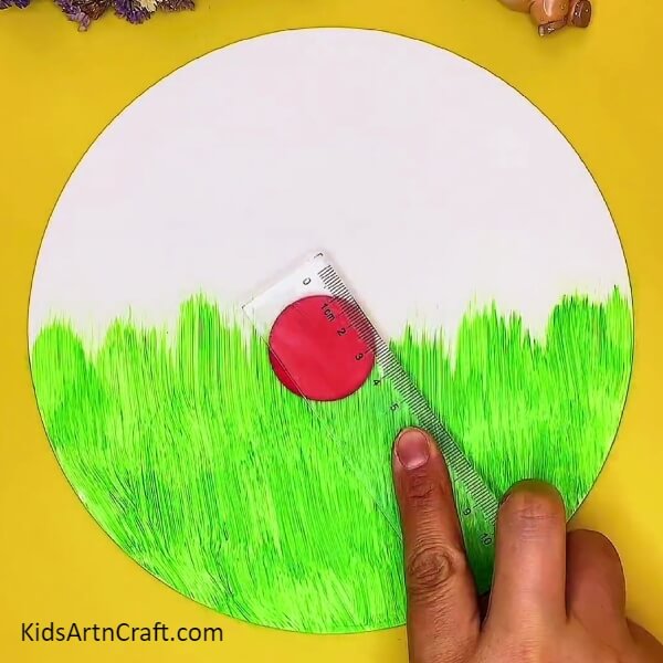 Making A Red Clay Circle-A clay craft concept featuring a ladybug and garden scene