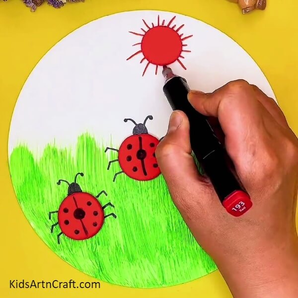 Drawing The Rays Of The Sun-A clay craft project with a ladybug and garden landscape