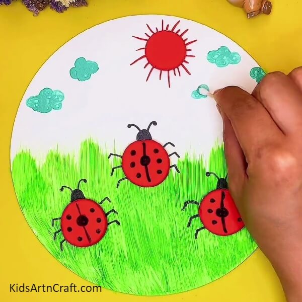 Painting The Clouds Using Cotton Buds-A clay creation of a ladybug and garden scene