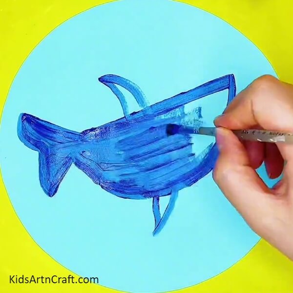 Make outline of the shark with dark blue poster colour- Mastering The Art Of Shark Painting Step-by-Step Guide