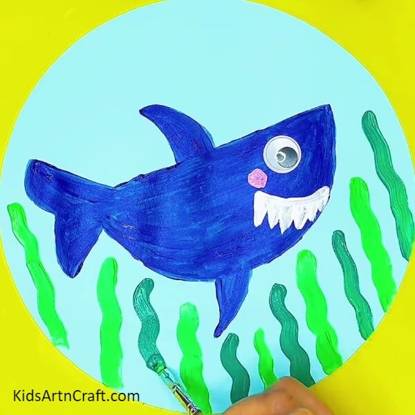 Make plants with dark green poster colour- Get A Step-by-Step Guide On Crafting Shark Paintings
