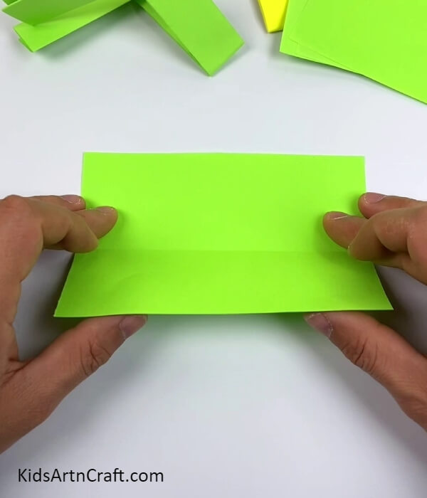 Folding The Paper Into Half-Designing an Easy And Creative Toy Gun Craft Using Origami Paper
