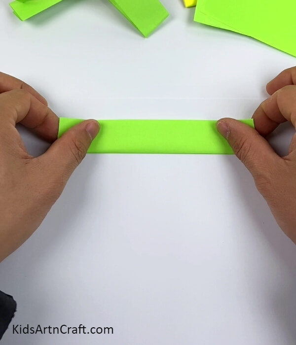 Folding The Paper Along The Crease-Learn To Make Paper Gun Using Paper And Glue