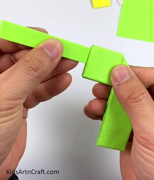 Inserting The Folded Strip In Gun Base-Origami Paper Craft For Kindergarten