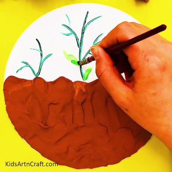 Painting Leaves- Creating outdoor art with clay and peanut shells 