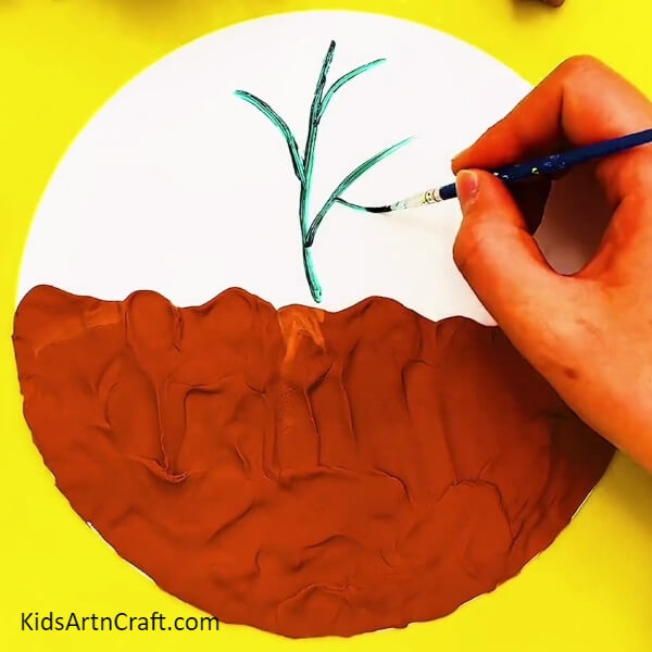 Painting Stems Of The Plants- Constructing a garden out of clay and peanut shells 