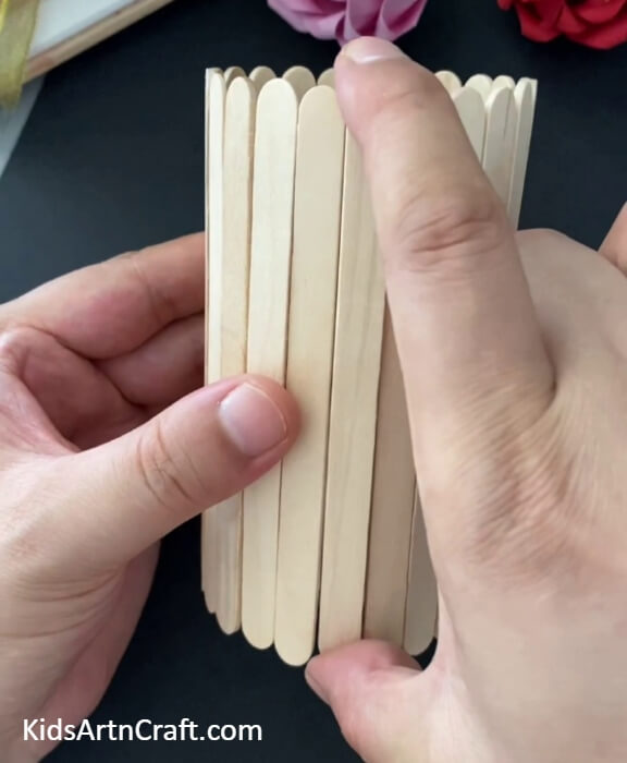 Covering The Bottle Base With Popsicle Sticks-Follow the guide to make a stunning DIY Popsicle Sticks Pencil Stand
