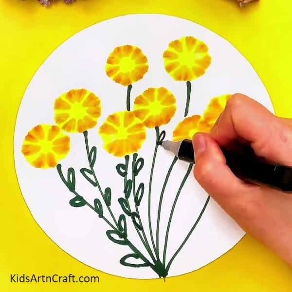 Drawing green leaves on sheet. Flower Artwork Using Sketch Pens And Cotton Earbuds for kids