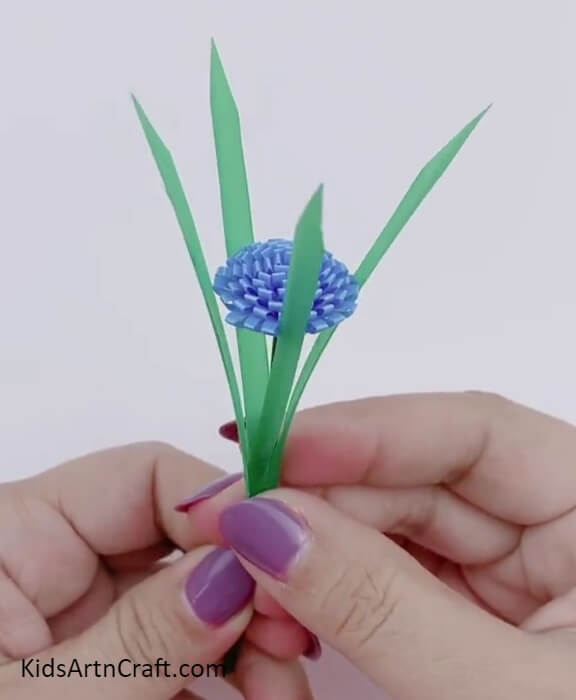 Pasting the leaves to the flower stem. Complete tutorial on how to make Pretty Straw Flower Bouquet Craft Tutorial For Kids