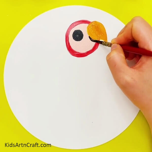 Making A Beak - A step by step guide to help kids paint a rainbow parrot.