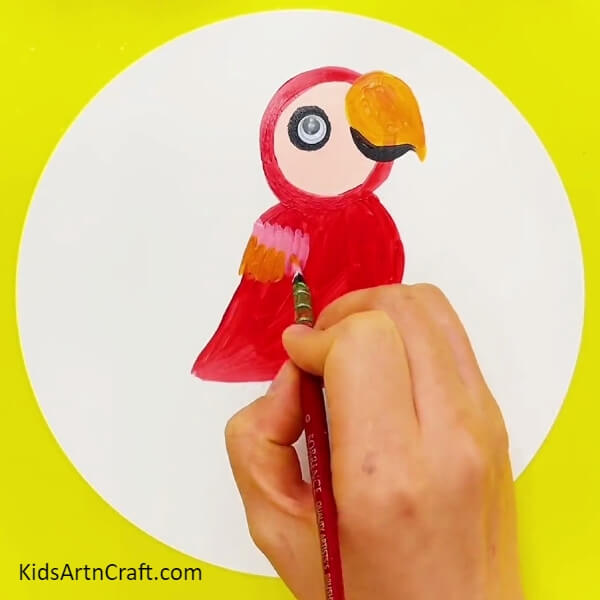 Making Rainbow Feathers Of The Parrot - Learn how to paint a rainbow parrot with this step-by-step guide specifically for kids.