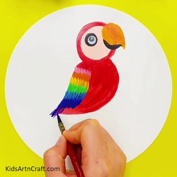 Completing Making The Feathers - This tutorial shows kids how to paint a rainbow parrot in easy steps.