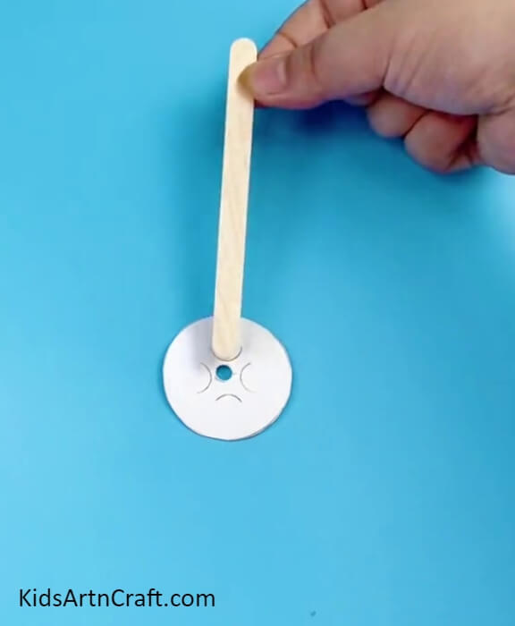 Pasting A Popsicle Stick Over Circle- Make a Fun Ferris Wheel with Recycled Sticks and Bottle Caps for the Children
