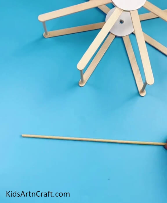 Taking A Wooden Stick-An Innovative Project for Kids: A Ferris Wheel with Repurposed Sticks and Bottle Caps