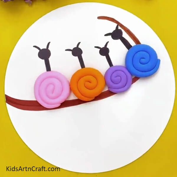 Making More Snails- Kids can make a clay-paper craftwork of snails on a tree branch. 