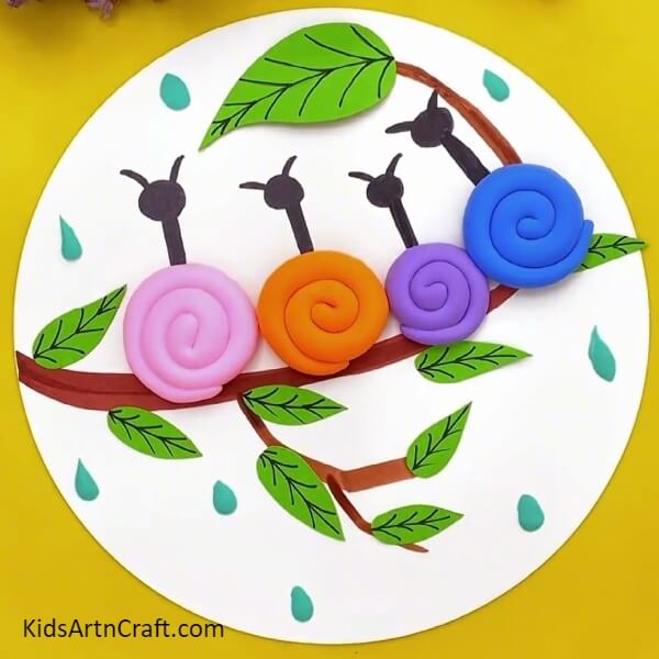 The Clay Snail Craft Is Ready!- Kids can make a clay-paper craft with snails on a tree branch. 