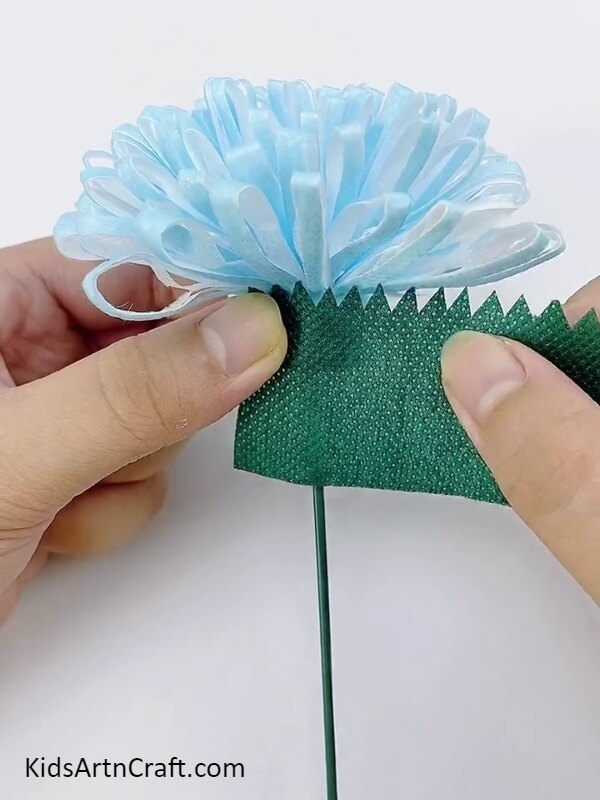 Wrap The Green Material Over The Stem- A Tutorial for Making Surgical Mask Flowers for Newcomers 